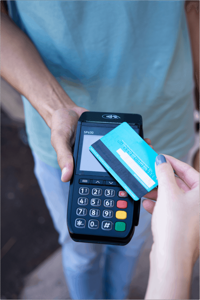 Close-up of hands performing contactless payment with credit card in Durban, South Africa.